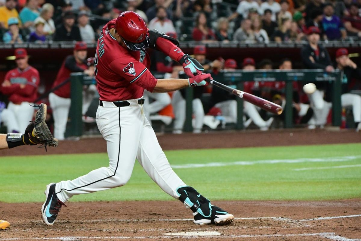 Jul 20, 2026; Phoenix, Arizona, USA; Arizona Diamondbacks third baseman Nolan Arenado (28) hits a double and records his 2000th career hit in the fifth inning against the Athletics at Chase Field. Mandatory Credit: Matt Kartozian-Imagn Images