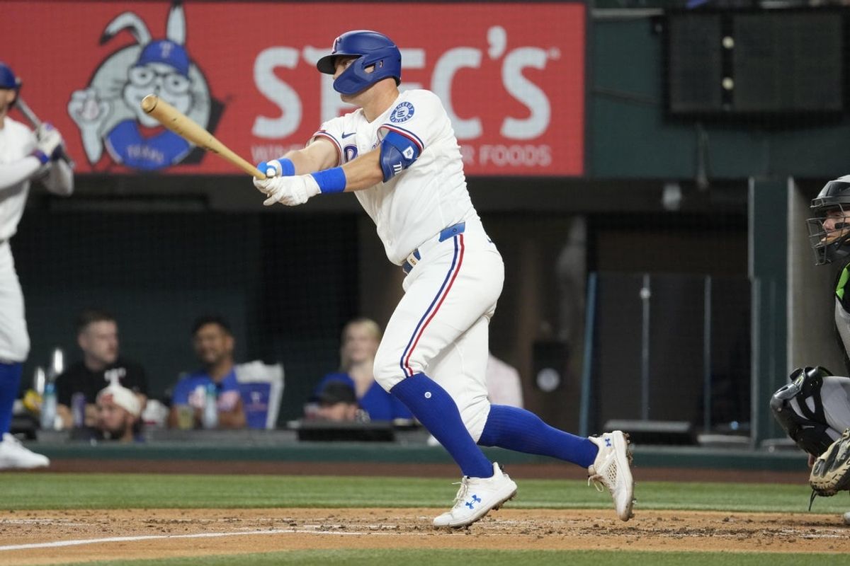 Jul 21, 2026; Arlington, Texas, USA; Texas Rangers third baseman Josh Jung (6) follows through on his single against the Chicago White Sox during the third inning at Globe Life Field. Mandatory Credit: Jim Cowsert-Imagn Images