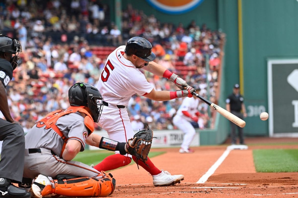 Jul 22, 2026; Boston, Massachusetts, USA; Boston Red Sox third baseman Caleb Durbin (5) hits a two run RBI double against the Baltimore Orioles during the first inning at Fenway Park. Mandatory Credit: Eric Canha-Imagn Images