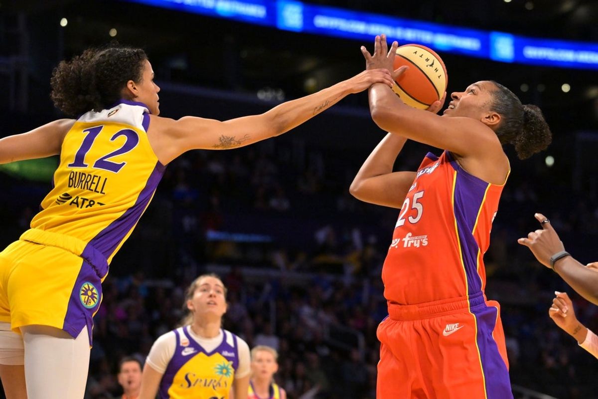 Jul 22, 2026; Los Angeles, California, USA;  Phoenix Mercury forward Alyssa Thomas (25) is fouled by Los Angeles Sparks guard Rae Burrell (12) as she drives to the basket during the first half at Crypto.com Arena. Mandatory Credit: Jayne Kamin-Oncea-Imagn Images
