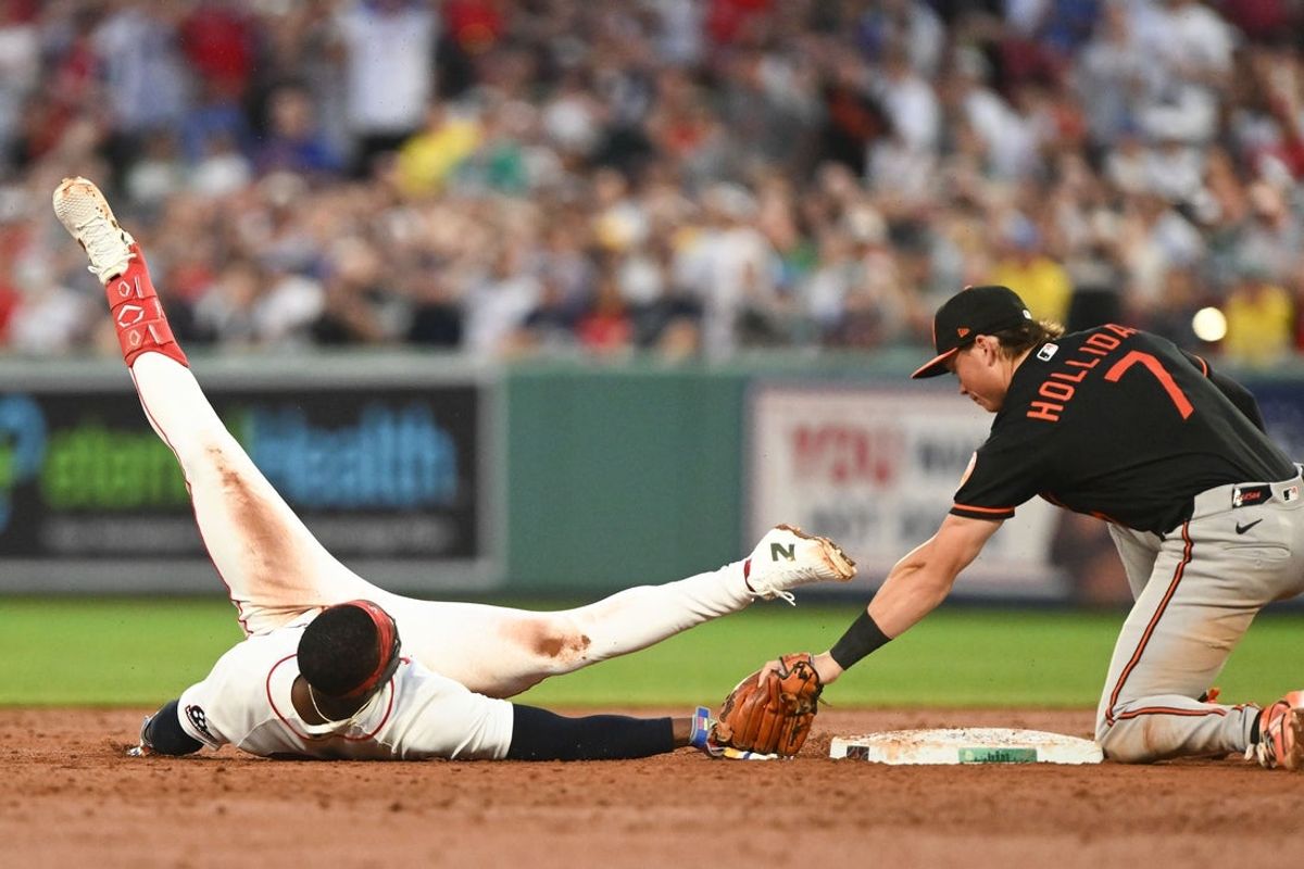 Jul 22, 2026; Boston, Massachusetts, USA; Baltimore Orioles second baseman Jackson Holliday (7) tags out Boston Red Sox shortstop Andruw Monasterio (32) during the third inning at Fenway Park. Mandatory Credit: Brian Fluharty-Imagn Images