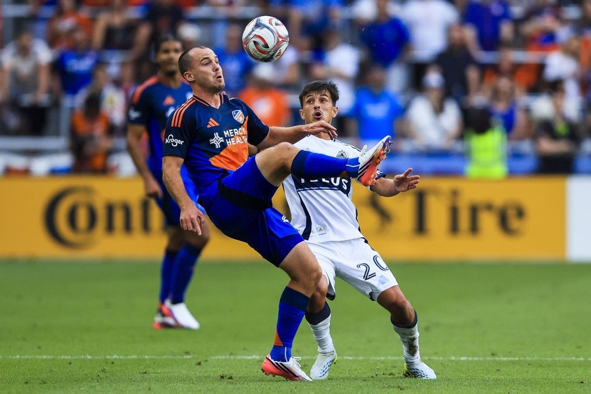 Jul 22, 2026; Cincinnati, Ohio, USA; FC Cincinnati midfielder Pavel Bucha (20) kicks the ball against Vancouver Whitecaps FC midfielder Andres Cubas (20) in the first half at TQL Stadium. Mandatory Credit: Katie Stratman-Imagn Images