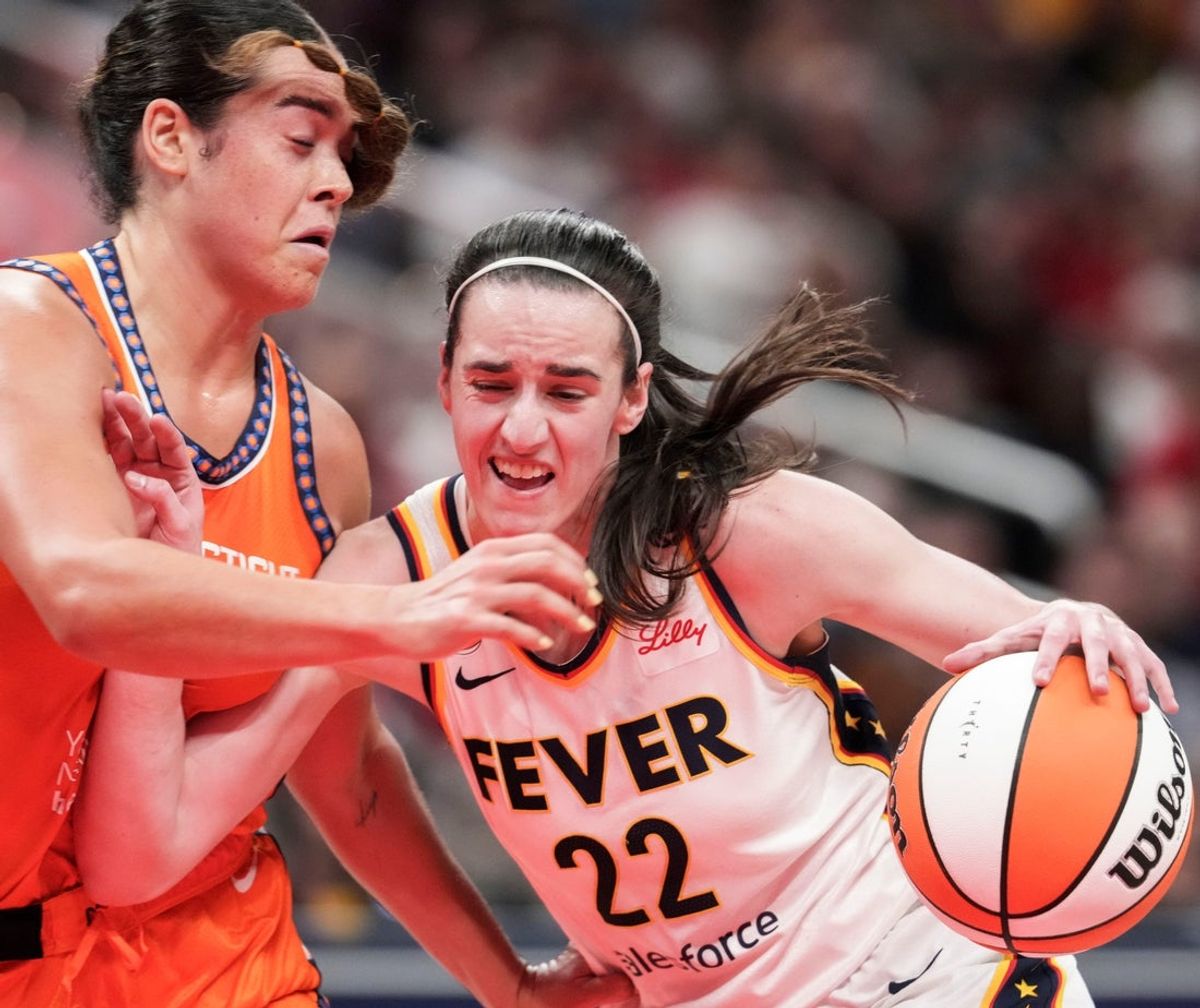 Connecticut Sun guard Charlisse Leger-Walker (4) guards Indiana Fever guard Caitlin Clark (22) on Wednesday, July 22, 2026, during a game at Gainbridge Fieldhouse in Indianapolis.