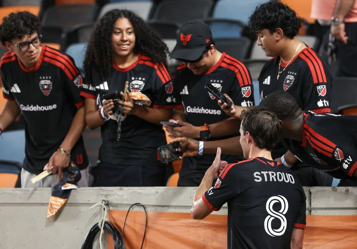 Jul 22, 2026; Houston, Texas, USA; D.C. United fans take  a photo of D.C. United midfield Jared Stroud (8) after he played against the Houston Dynamo FC  at Shell Energy Stadium. Mandatory Credit: Thomas Shea-Imagn Images