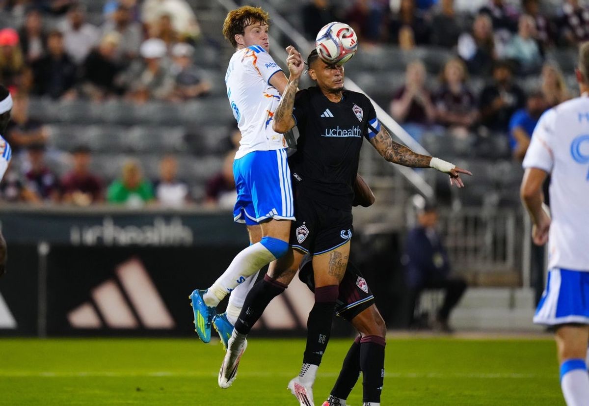 Jul 22, 2026; Commerce City, Colorado, USA;  San Diego FC defense Kieran Sargeant (5) and Colorado Rapids offense Rafael Navarro (9) reach for the ball during the second half at Dick's Sporting Goods Park. Mandatory Credit: Ron Chenoy-Imagn Images