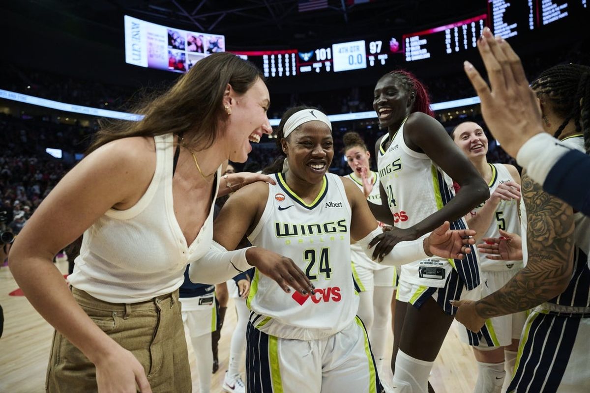Jul 22, 2026; Portland, Oregon, USA; Dallas Wings guard Arike Ogunbowale (24) celebrates with teammates after a game against the Portland Fire at Moda Center. Mandatory Credit: Troy Wayrynen-Imagn Images