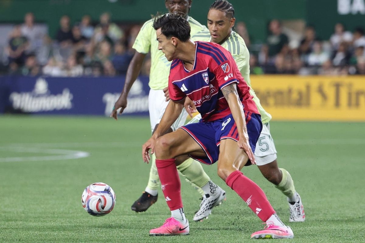 Jul 22, 2026; Portland, Oregon, USA;  FC Dallas offense Petar Musa (9) and Portland Timbers defense Brandon Bye (5) battle for the ball in the second half at Providence Park. Mandatory Credit: Jaime Valdez-Imagn Images