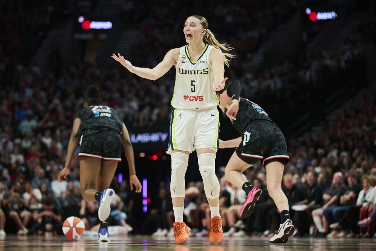 Jul 22, 2026; Portland, Oregon, USA; Dallas Wings guard Paige Bueckers (5) reacts toward a referee as Portland Fire forward Serah Williams (25) steals the basketball during the second half at Moda Center. Mandatory Credit: Troy Wayrynen-Imagn Images