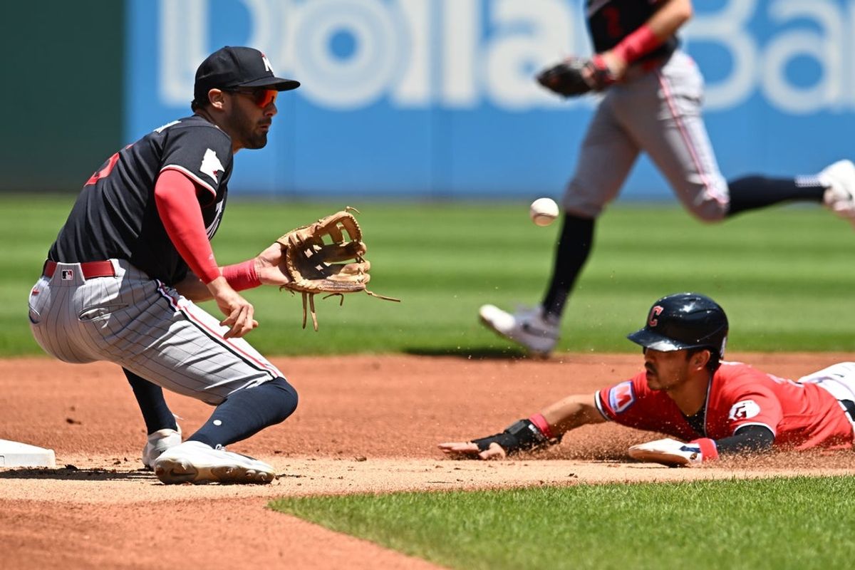Jul 23, 2026; Cleveland, Ohio, USA; Minnesota Twins shortstop Ryan Kreidler (5) waits for the ball as Cleveland Guardians left fielder Steven Kwan (38) steals second base during the first inning at Progressive Field. Mandatory Credit: Ken Blaze-Imagn Images