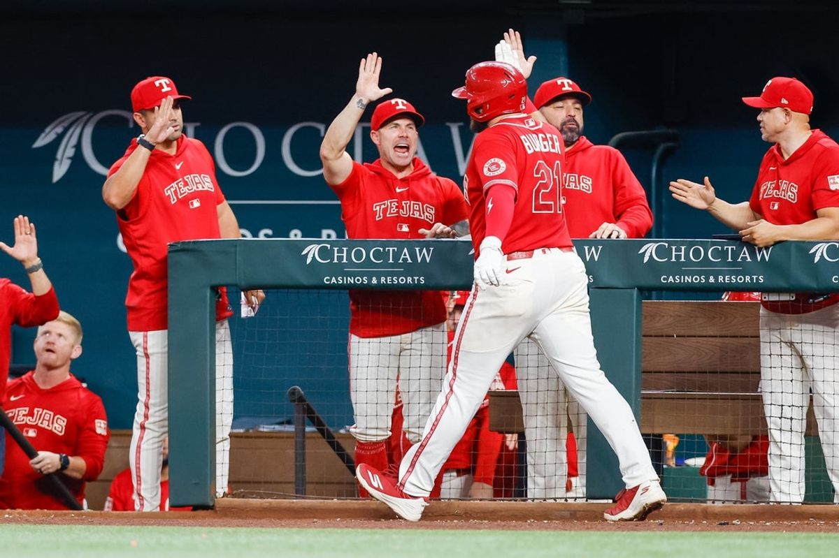 Jul 24, 2026; Arlington, Texas, USA; Texas Rangers first baseman Jake Burger (21) hits a two run home run during the fourth inning against the Seattle Mariners at Globe Life Field. Mandatory Credit: Andrew Dieb-Imagn Images