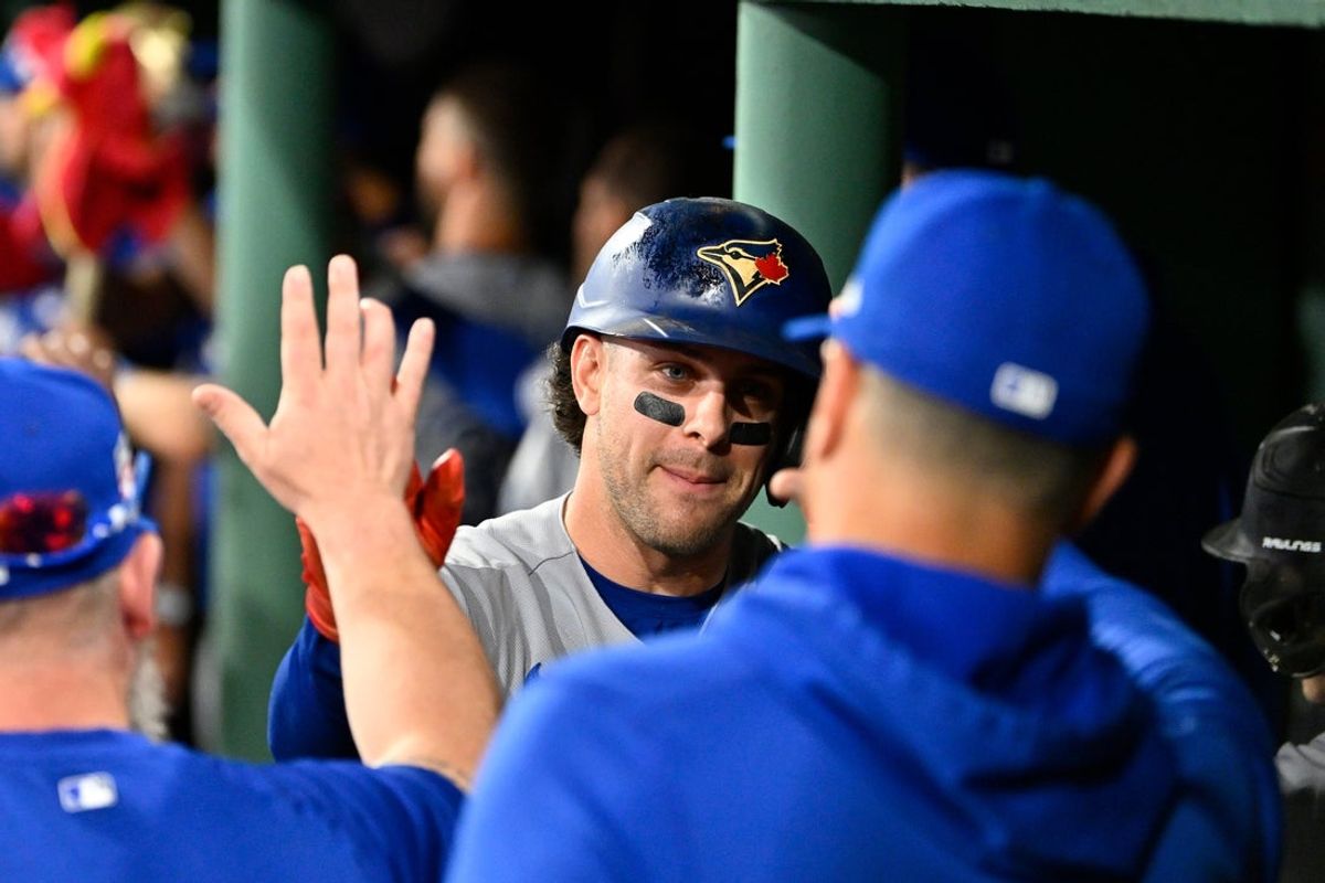 Jul 24, 2026; Boston, Massachusetts, USA; Toronto Blue Jays shortstop Ernie Clement (22) celebrates scoring a run off a home run by third baseman Kazuma Okamoto (7) during the seventh inning against the Boston Red Sox at Fenway Park. Mandatory Credit: Eric Canha-Imagn Images