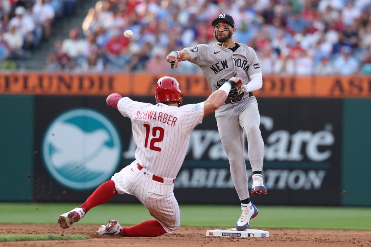 Jul 25, 2026; Philadelphia, Pennsylvania, USA; New York Yankees shortstop Jose Caballero (72) throws for a double play after tagging out Philadelphia Phillies designated hitter Kyle Schwarber (12) during the third inning at Citizens Bank Park. Mandatory Credit: Bill Streicher-Imagn Images