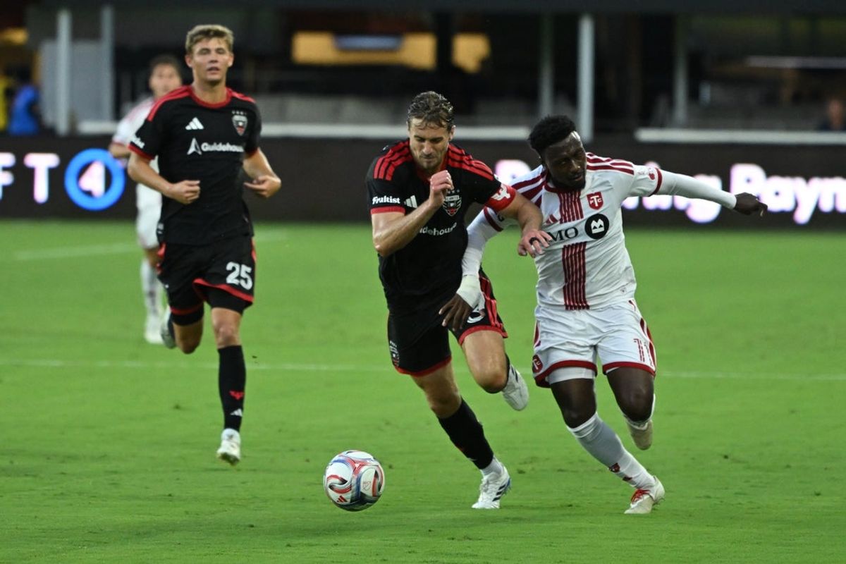 Jul 25, 2026; Washington, District of Columbia, USA; D.C. United defender Lucas Bartlett (3) and Toronto FC forward Derrick Etienne Jr. (11) battle for the ball during the first half at Audi Field. Mandatory Credit: Rafael Suanes-Imagn Images