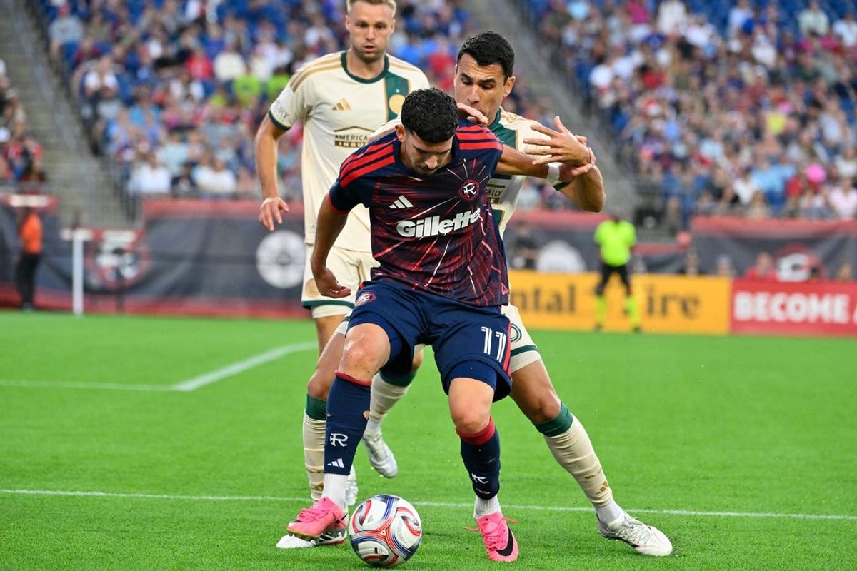 Jul 25, 2026; Foxborough, Massachusetts, USA; New England Revolution forward Dor Turgeman (11) protects the ball from Atlanta United defense Junior Alonso (6) during the first half at Gillette Stadium. Mandatory Credit: Eric Canha-Imagn Images