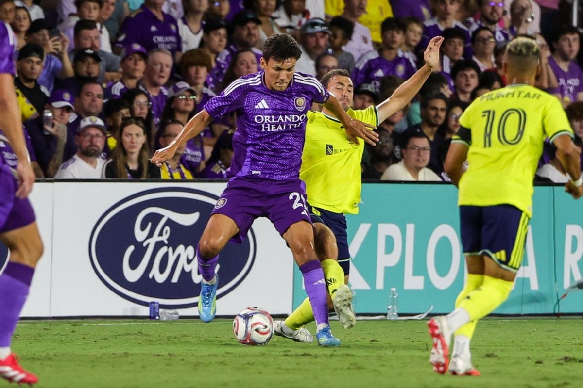Jul 25, 2026; Orlando, Florida, USA; Orlando City SC forward Justin Ellis (22) battles for the ball against Nashville SC defense Jack Maher (5) during the first half at Inter.Co Stadium. Mandatory Credit: Mike Watters-Imagn Images