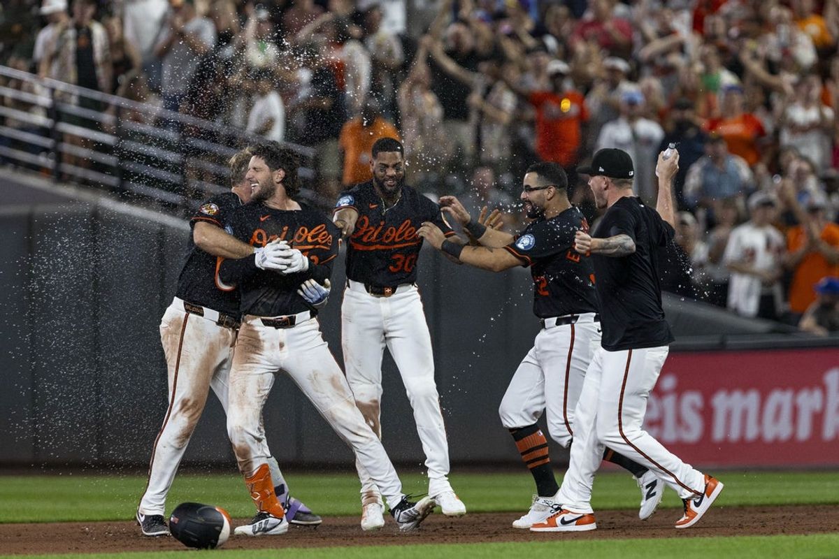 Jul 25, 2026; Baltimore, Maryland, USA; Baltimore Orioles right fielder Dylan Beavers (12) is sprayed with water by teammates after a walk-off single in the ninth inning against Atlanta Braves at Oriole Park at Camden Yards. Mandatory Credit: Lexi Thompson-Imagn Images