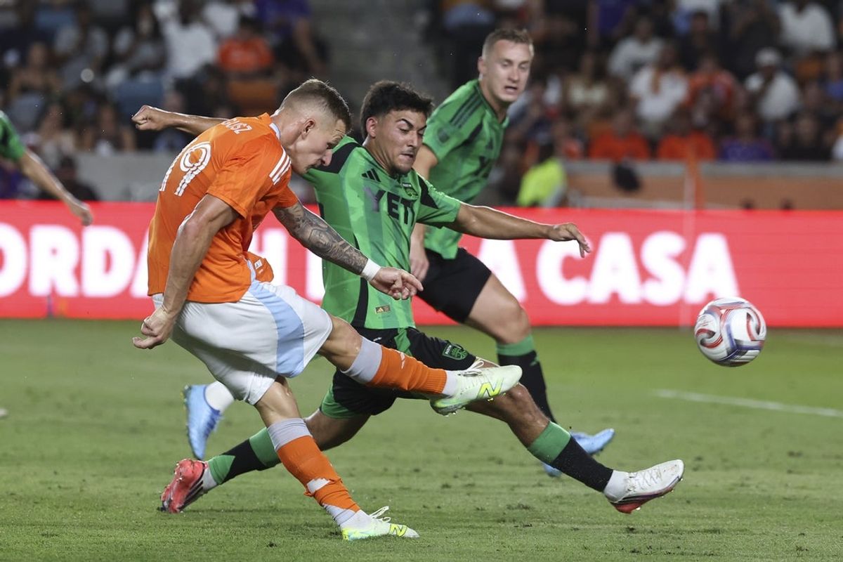 Jul 25, 2026; Houston, Texas, USA; Houston Dynamo FC midfielder Mateusz Bogusz (19) shoots the ball past Austin FC midfielder Owen Wolff (33) during the second half at Shell Energy Stadium. Mandatory Credit: Troy Taormina-Imagn Images