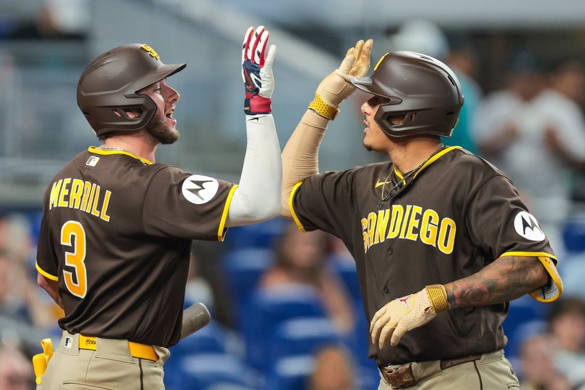 Jul 26, 2026; Miami, Florida, USA; San Diego Padres third baseman Manny Machado (13) celebrates with center fielder Jackson Merrill (3) after hitting a two-run home run against the Miami Marlins during the eighth inning at loanDepot Park. Mandatory Credit: Sam Navarro-Imagn Images