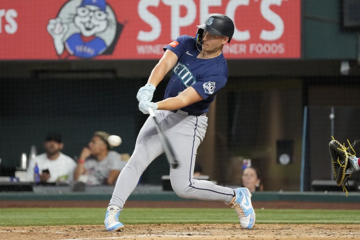 Jul 26, 2026; Arlington, Texas, USA; Seattle Mariners designated hitter Dominic Canzone (8) singles against the Texas Rangers during the sixth inning at Globe Life Field. Mandatory Credit: Jim Cowsert-Imagn Images
