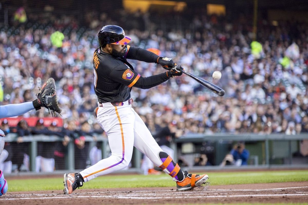 Jul 28, 2026; San Francisco, California, USA;  San Francisco Giants left fielder Heliot Ramos (17) hits a single against the Milwaukee Brewers during the first inning at Oracle Park. Mandatory Credit: John Hefti-Imagn Images