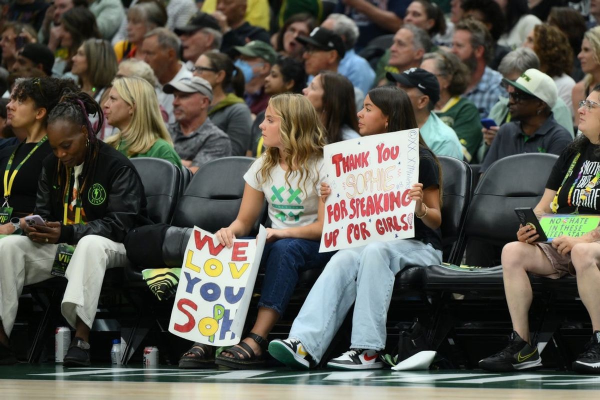 Jul 28, 2026; Seattle, Washington, USA; Fan hold a Indiana Fever guard Sophie Cunningham (8) (not pictured) sign during the first half between the Seattle Storm and the Indiana Fever at Climate Pledge Arena. Mandatory Credit: Steven Bisig-Imagn Images