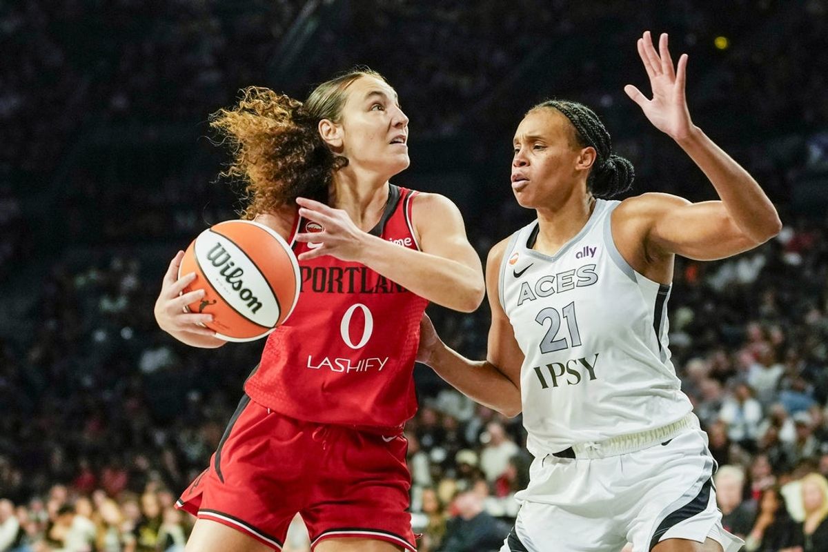 Jul 28, 2026; Las Vegas, Nevada, USA; Portland Fire guard Carla Leite (0) drives the ball against Las Vegas Aces forward-center Brianna Turner (21) during the second quarter of a WNBA basketball game at Michelob Ultra Arena. Mandatory Credit: Lucas Peltier-Imagn Images
