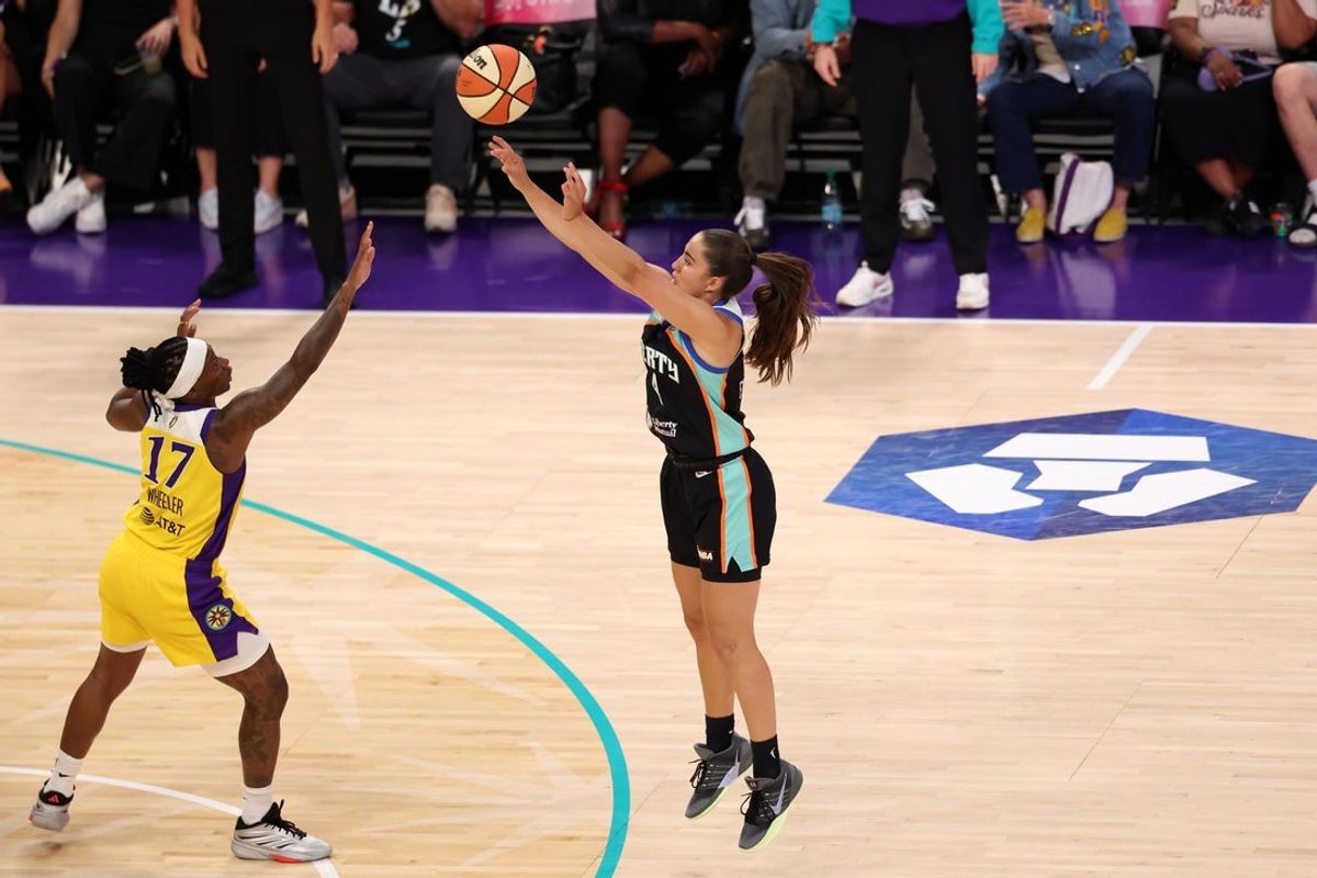 Jul 28, 2026; Los Angeles, California, USA;  New York Liberty guard Marine Fauthoux (4) shoots a three point basket over Los Angeles Sparks guard Erica Wheeler (17) during the second quarter at Crypto.com Arena. Mandatory Credit: Kiyoshi Mio-Imagn Images