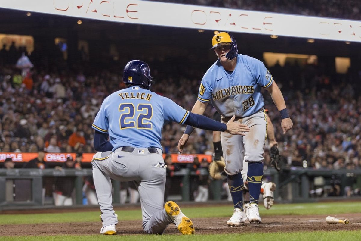 Jul 28, 2026; San Francisco, California, USA;  Milwaukee Brewers first baseman Andrew Vaughn (28) is congratulated by designated hitter Christian Yelich (22) after he scored against the San Francisco Giants against the San Francisco Giants during the seventh inning at Oracle Park. Mandatory Credit: John Hefti-Imagn Images