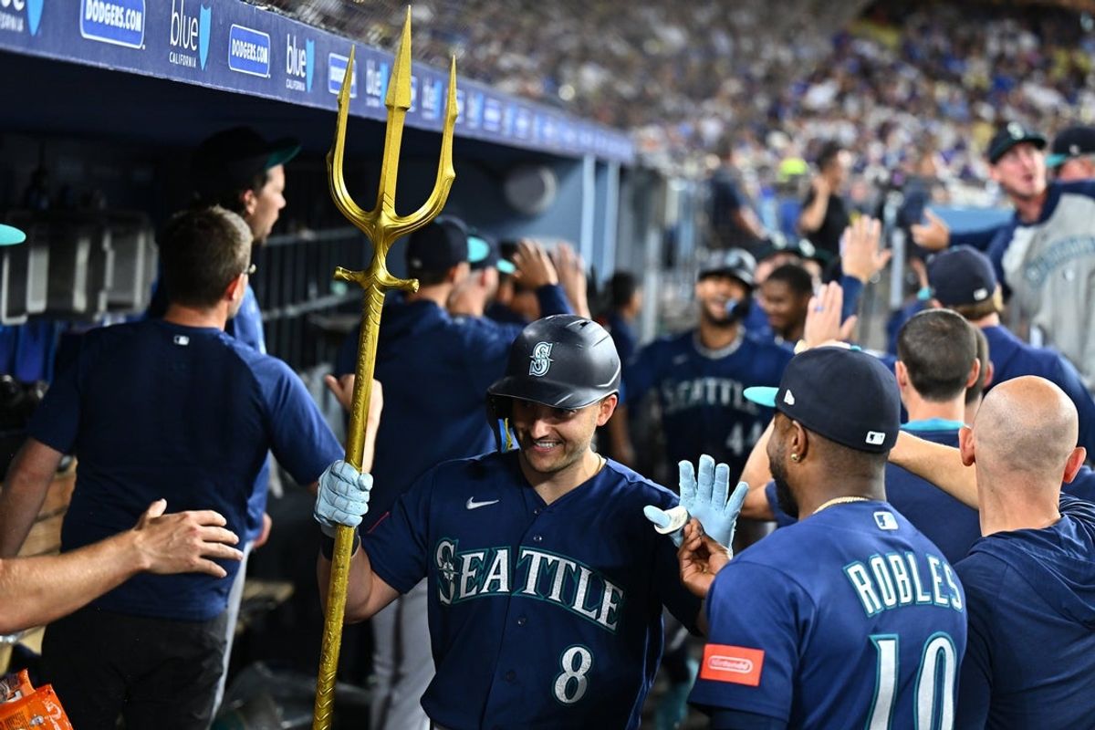 Jul 28, 2026; Los Angeles, California, USA; Seattle Mariners right fielder Dominic Canzone (8) is greeted by teammates after hitting a two-run home run during the eighth inning against the Los Angeles Dodgers at Dodger Stadium. Mandatory Credit: William Liang-Imagn Images