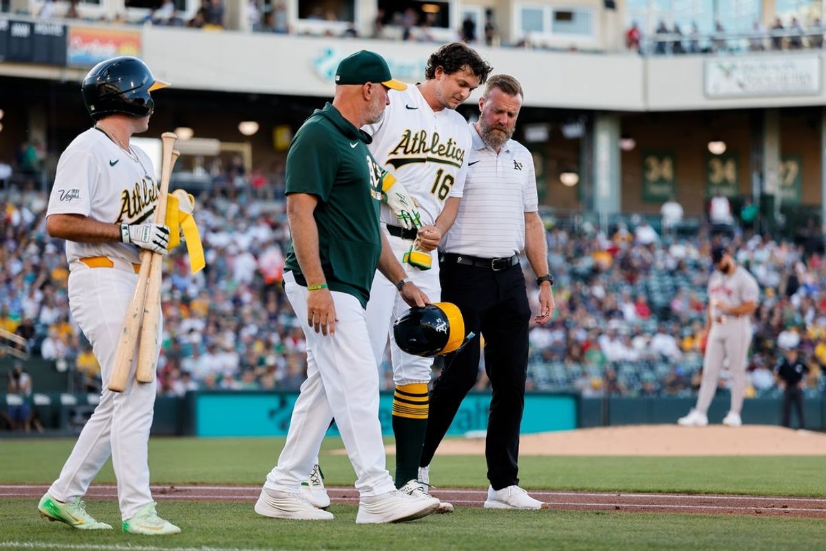 Jul 29, 2026; West Sacramento, California, USA; Athletics first baseman Nick Kurtz (16) is looked at by manager Mark Kotsay (7) and a staff member after getting hit by a pitch during the first inning against the Boston Red Sox at Sutter Health Park. Mandatory Credit: Sergio Estrada-Imagn Images