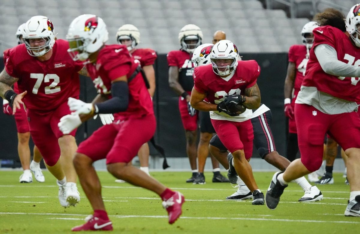 Cardinals running back Tyler Allgeier (22) runs with the ball during training camp at State Farm Stadium in Glendale on July 28, 2026.