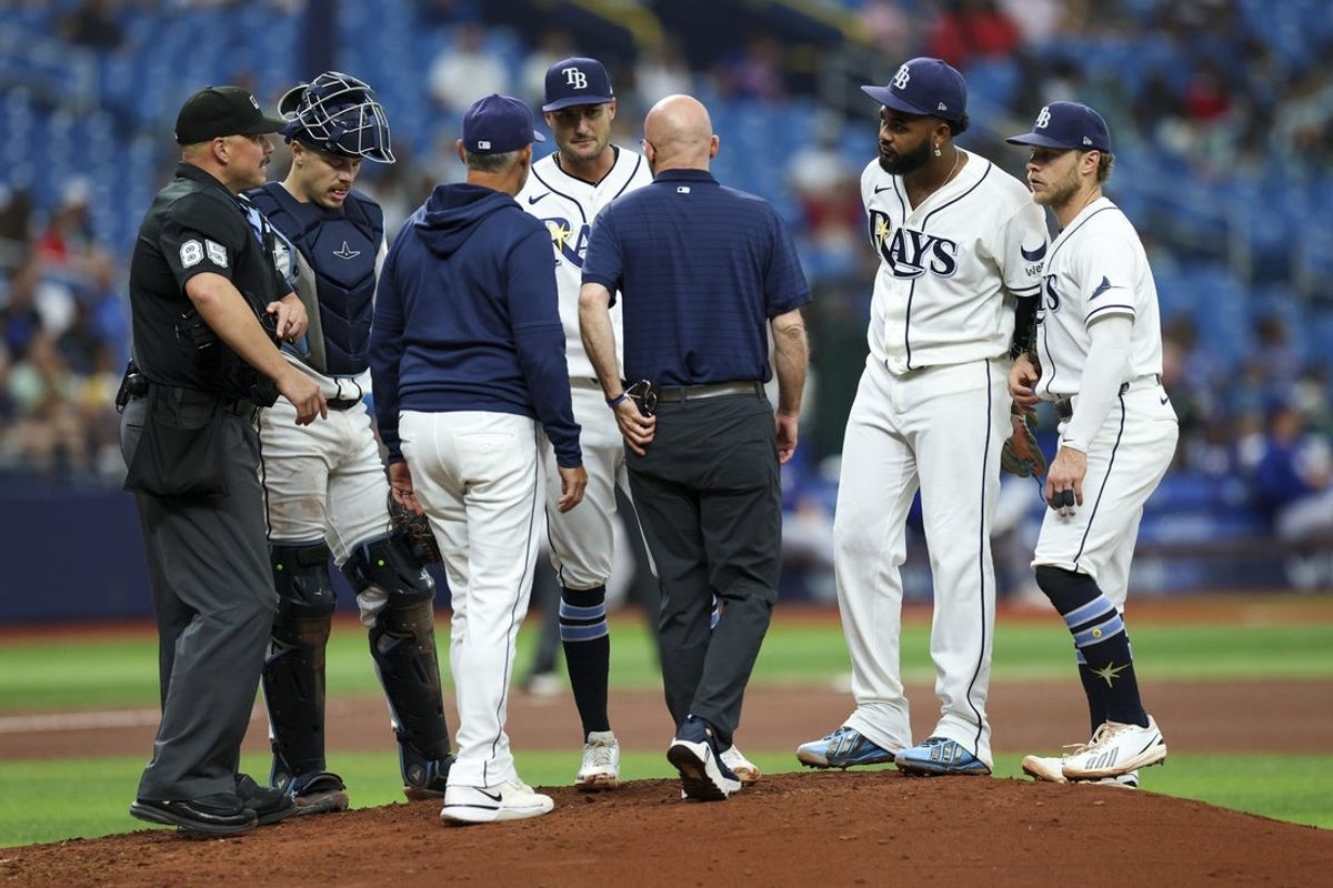 Jul 30, 2026; St. Petersburg, Florida, USA; Tampa Bay Rays starting pitcher Shane McClanahan (18) leaves the game with the trainer against the Texas Rangers in the fourth inning at Tropicana Field. Mandatory Credit: Nathan Ray Seebeck-Imagn Images