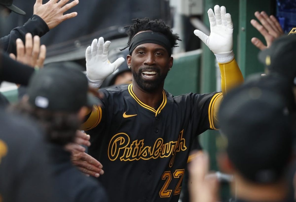 Apr 23, 2024; Pittsburgh, Pennsylvania, USA;  Pittsburgh Pirates designated hitter Andrew McCutchen (22) celebrates his solo home run in the dugout against the Milwaukee Brewers during the first inning at PNC Park.