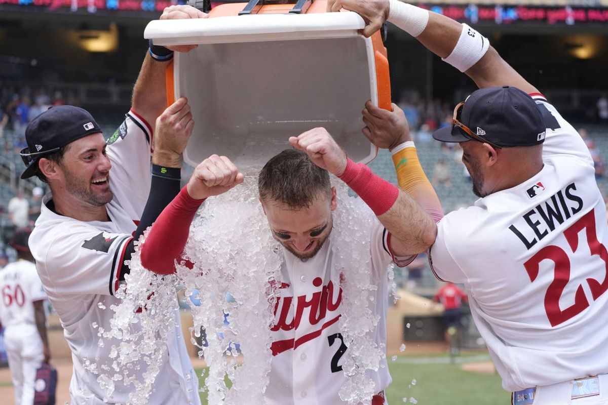 Jul 30, 2026; Minneapolis, Minnesota, USA; Minnesota Twins shortstop Ryan Kreidler (5) and second baseman Royce Lewis (23) dump ice on right fielder Kody Clemens (2) after the right fielder hit a walk-off grand slam against the Kansas City Royals in the ninth inning at Target Field. Mandatory Credit: Bruce Kluckhohn-Imagn Images