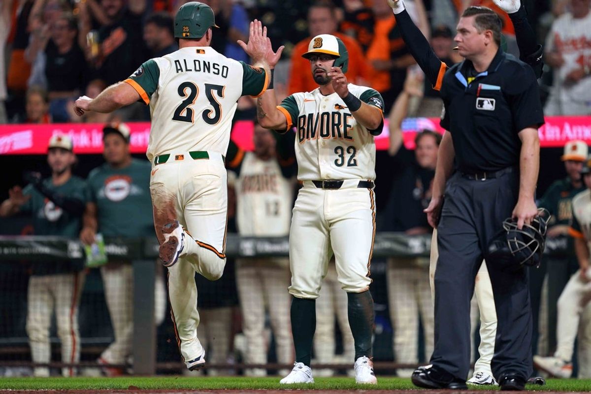 Jul 31, 2026; Baltimore, Maryland, USA; Baltimore Orioles first baseman Pete Alonso (25) celebrates with pinch hitter Christian Encarnacion-Strand (32) after scoring on a two RBI triple hit by shortstop Gunnar Henderson (not pictured) during the seventh inning against the Philadelphia Phillies at Oriole Park at Camden Yards. Mandatory Credit: Mitch Stringer-Imagn Images