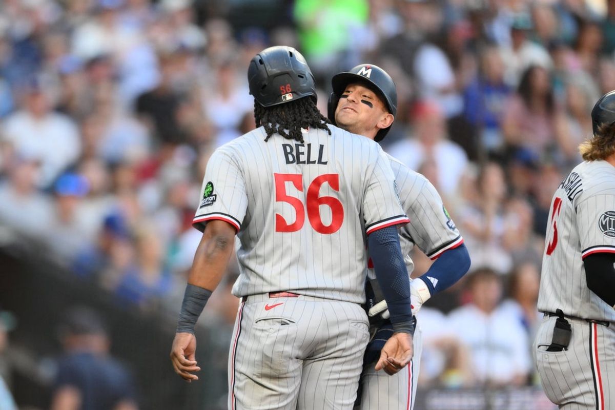 Jul 31, 2026; Seattle, Washington, USA; Minnesota Twins designated hitter Josh Bell (56) and third baseman Brooks Lee (22) celebrate after a 2-run home run hit by Lee during the second inning against the Seattle Mariners at T-Mobile Park. Mandatory Credit: Steven Bisig-Imagn Images