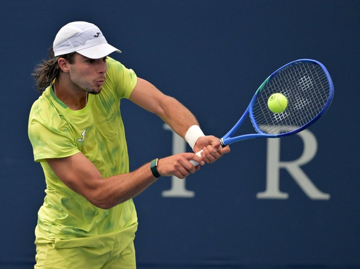 Aug 1, 2026; Montreal, QC, Canada; Jaime Faria (POR) hits a backhand against Christopher O Connell (AUS) during qualifying play at IGA stadium. Mandatory Credit: Eric Bolte-Imagn Images