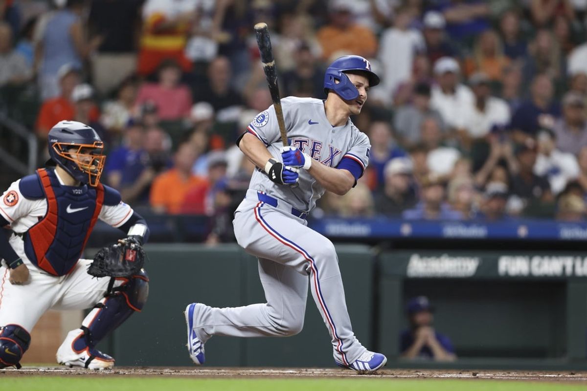 Aug 1, 2026; Houston, Texas, USA; Texas Rangers shortstop Corey Seager (5) hits a single during the first inning against the Houston Astros at Daikin Park. Mandatory Credit: Troy Taormina-Imagn Images
