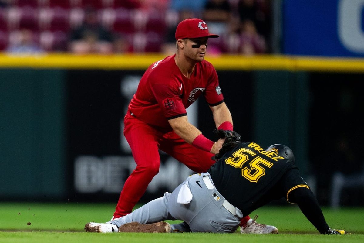 Cincinnati Reds second baseman Matt McLain (9) tags out Pittsburgh Pirates right fielder Esmerlyn Valdez (55) on his way to second in the third inning between the Pittsburgh Pirates and Cincinnati Reds at Great American Ball Park in Cincinnati on Saturday, August 1, 2026.
