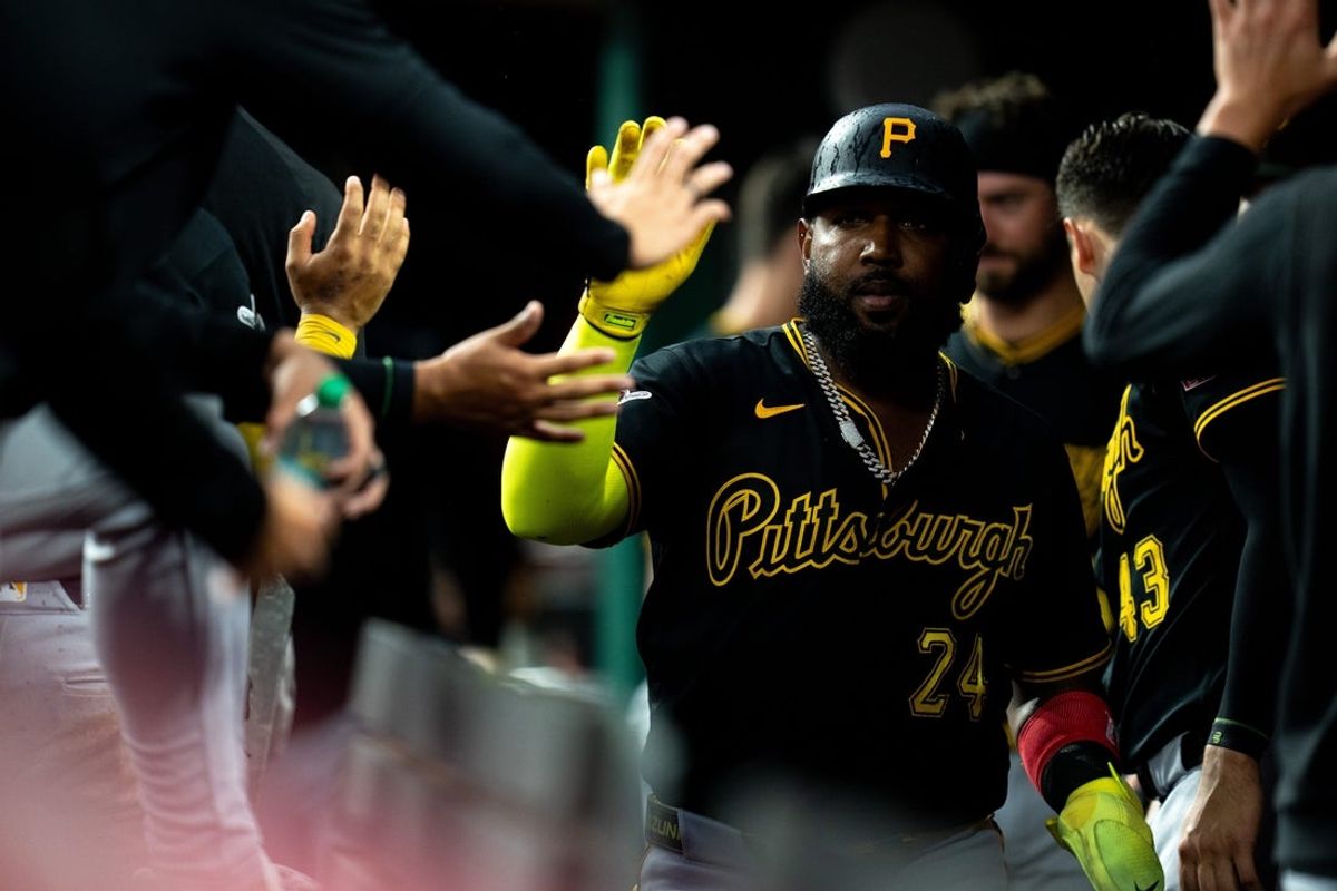 Pittsburgh Pirates designated hitter Marcell Ozuna (24) high fives teammates after scoring on a base hit by Pittsburgh Pirates catcher Henry Davis (32) in the sixth inning between the Pittsburgh Pirates and Cincinnati Reds at Great American Ball Park in Cincinnati on Saturday, August 1, 2026.