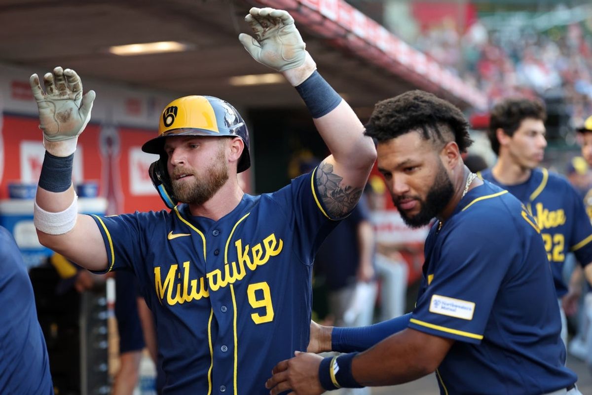 Aug 1, 2026; Anaheim, California, USA;  Milwaukee Brewers right fielder Jake Bauers (9) is greeted by left fielder Jackson Chourio (11) in the dugout after hitting a home run during the fourth inning against the Los Angeles Angels at Angel Stadium. Mandatory Credit: Kiyoshi Mio-Imagn Images