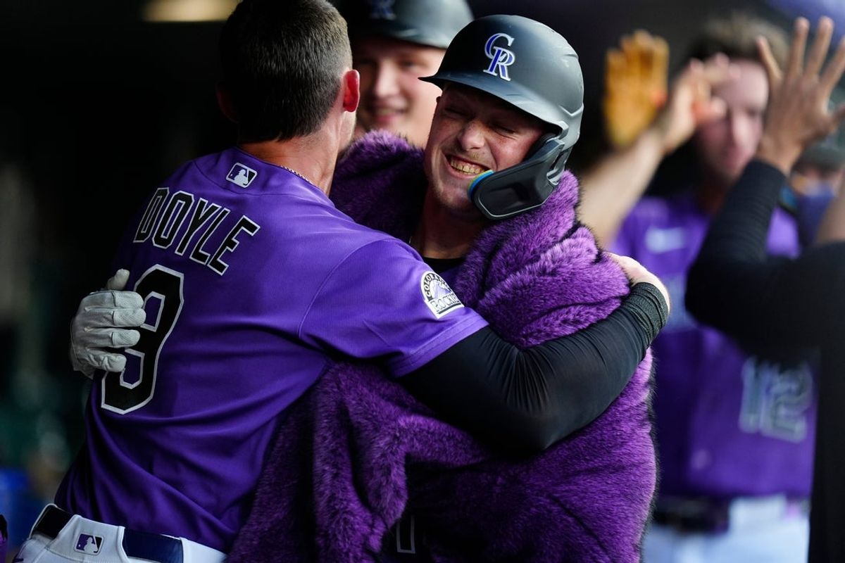 Aug 1, 2026; Denver, Colorado, USA; Colorado Rockies catcher Hunter Goodman (15) celebrates with center fielder Brenton Doyle (9) in the dugout after hitting a three run home run during the third inning against the Kansas City Royals at Coors Field. Mandatory Credit: Ron Chenoy-Imagn Images