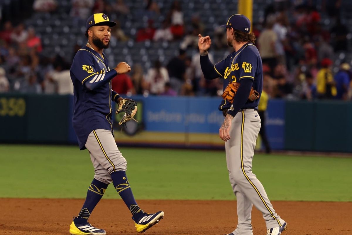 Aug 1, 2026; Anaheim, California, USA;  Milwaukee Brewers left fielder Jackson Chourio (11) celebrates with second baseman Brice Turang (2) after a 3-1 victory over the Los Angeles Angels at Angel Stadium. Mandatory Credit: Kiyoshi Mio-Imagn Images