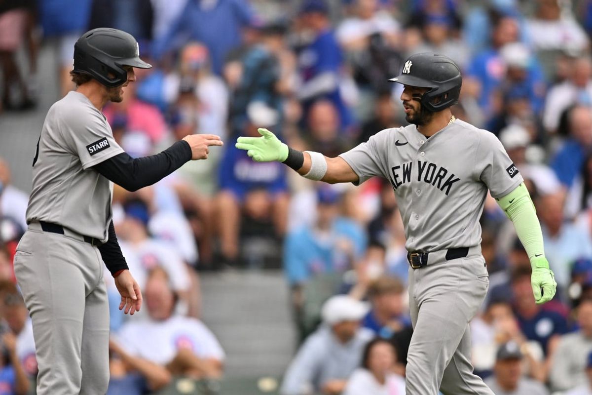 Aug 2, 2026; Chicago, Illinois, USA; New York Yankees shortstop Jose Caballero (72) celebrates with third baseman Ryan McMahon (19) after hitting a two-run home run against the Chicago Cubs during the third inning at Wrigley Field. Mandatory Credit: Patrick Gorski-Imagn Images