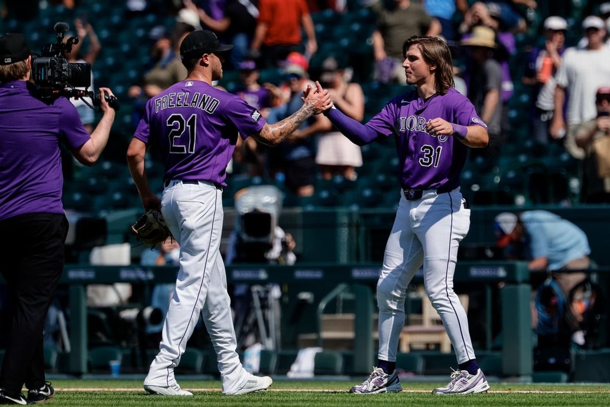 Aug 2, 2026; Denver, Colorado, USA; Colorado Rockies starting pitcher Kyle Freeland (21) celebrates with designated hitter Jake McCarthy (31) after the game against the Kansas City Royals at Coors Field. Mandatory Credit: Isaiah J. Downing-Imagn Images