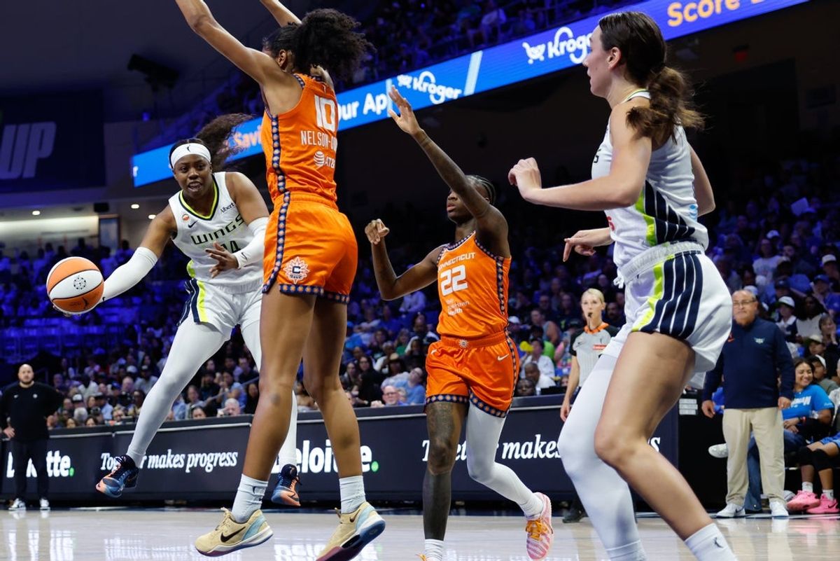 Aug 2, 2026; Arlington, Texas, USA;  Dallas Wings guard Arike Ogunbowale (24) passes the ball as Connecticut Sun center Olivia Nelson-Ododa (10) defends during the first half at College Park Center. Mandatory Credit: Chris Jones-Imagn Images
