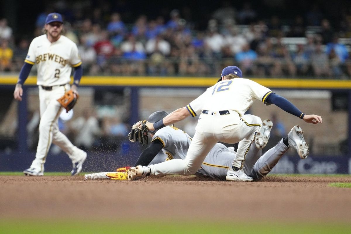 Aug 3, 2026; Milwaukee, Wisconsin, USA; Milwaukee Brewers second baseman Cooper Pratt (12) attempts to tag out Pittsburgh Pirates first baseman Endy Rodriquez (13) while stealing second base in the eighth inning at American Family Field. Mandatory Credit: Michael McLoone-Imagn Images