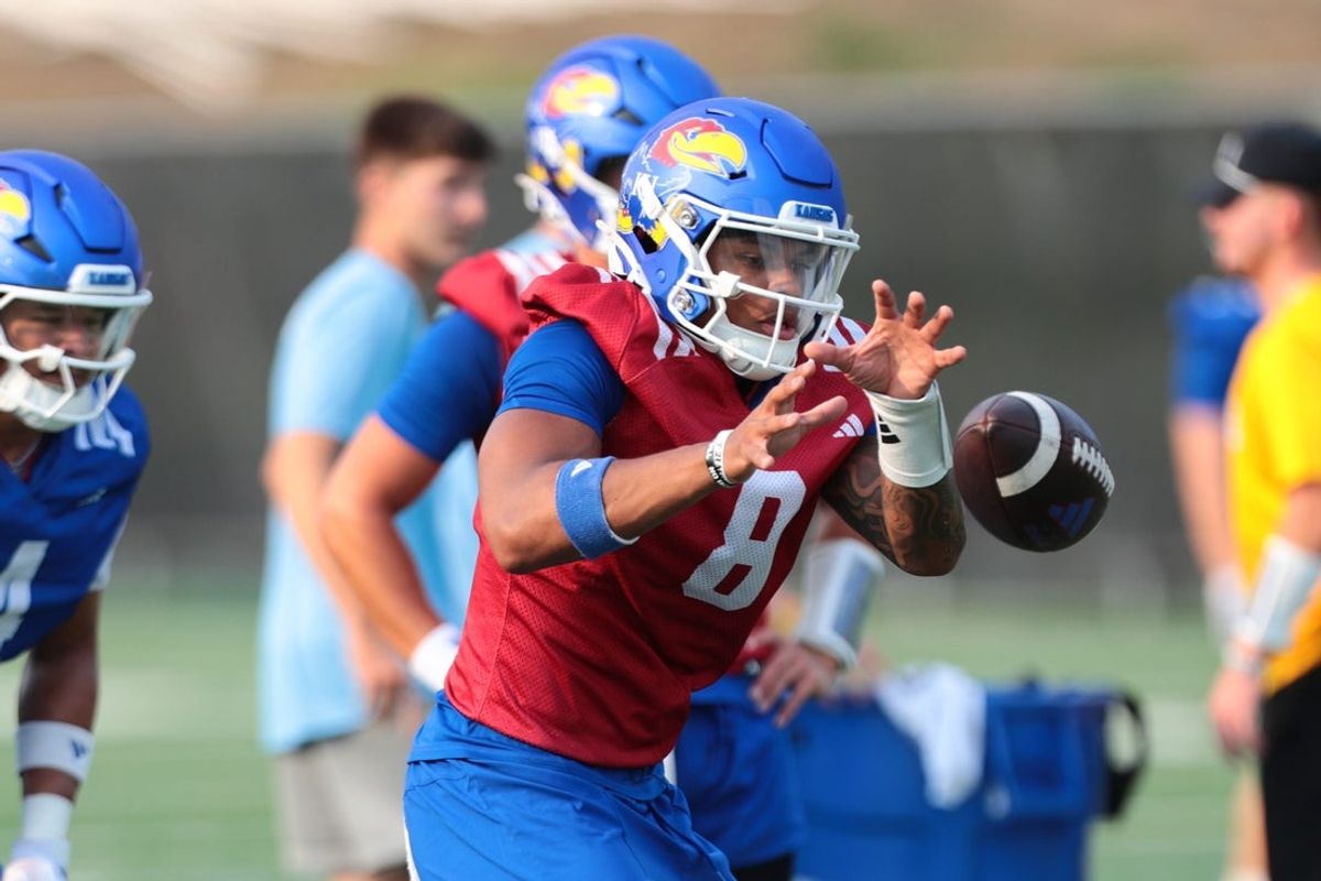 Kansas redshirt sophomore quarterback Isaiah Marshall (8) works on a drill during fall camp practice on Aug. 4, 2026.