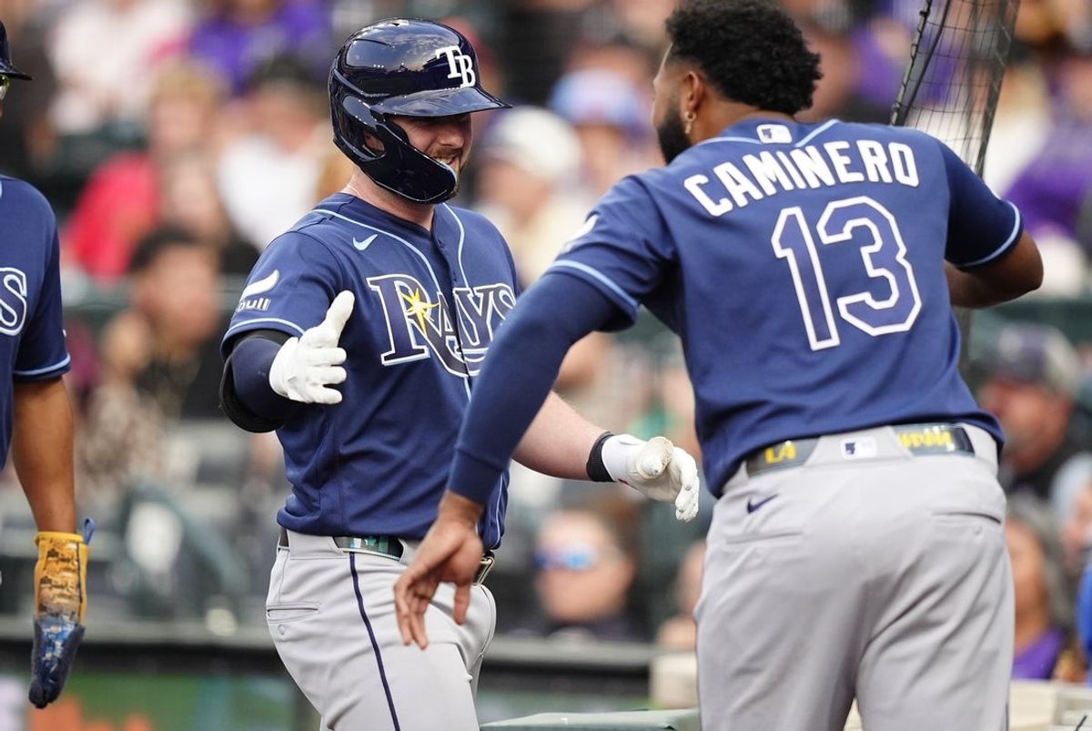 Aug 4, 2026; Denver, Colorado, USA; Tampa Bay Rays catcher Liam Hicks (34) celebrates his grand slam with third baseman Junior Caminero (13) in the third inning against the Colorado Rockies at Coors Field. Mandatory Credit: Ron Chenoy-Imagn Images