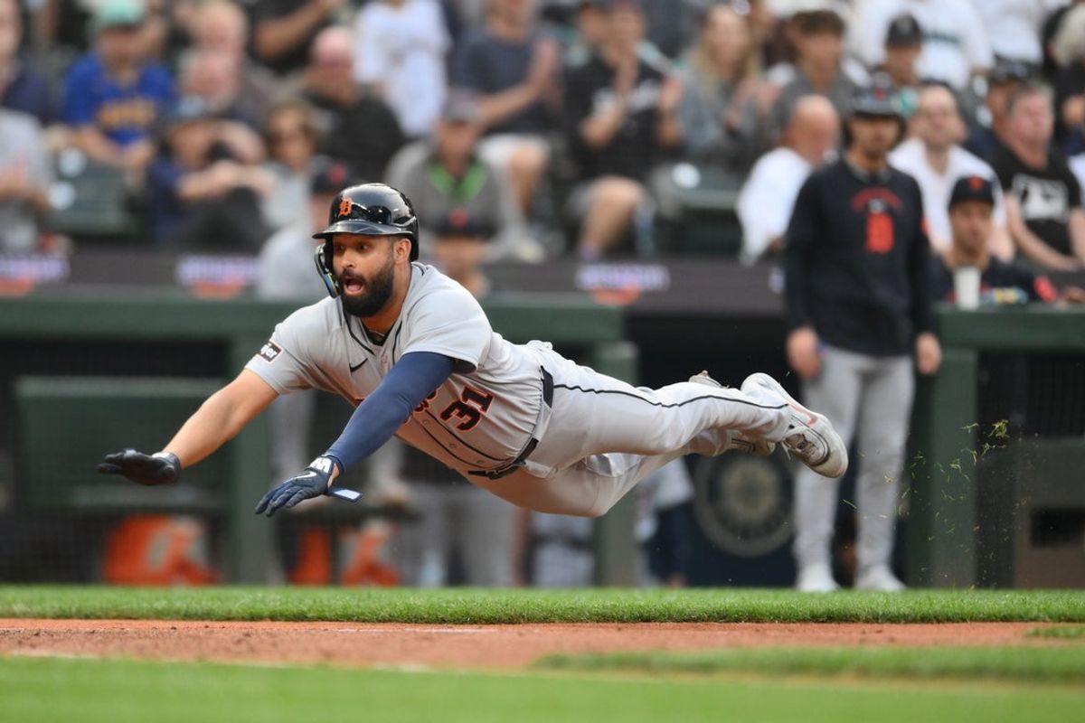 Aug 4, 2026; Seattle, Washington, USA; Detroit Tigers left fielder Riley Greene (31) dives into home plate to score a run against the Seattle Mariners during the third inning at T-Mobile Park. Mandatory Credit: Steven Bisig-Imagn Images